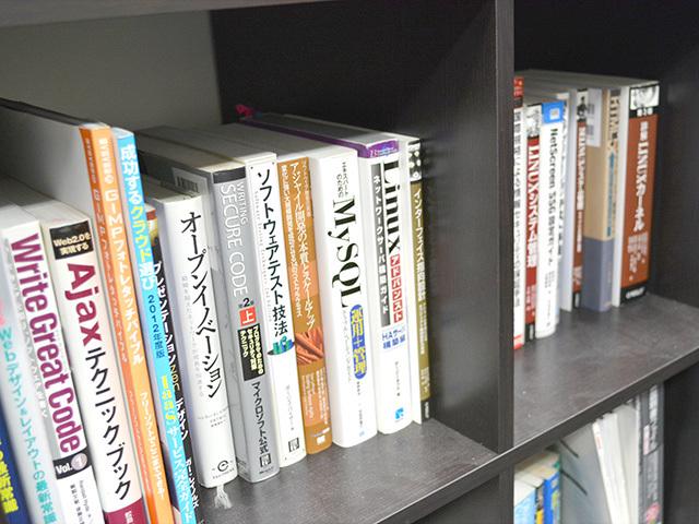 会社購入のIT関連書籍が多く並ぶ本棚。