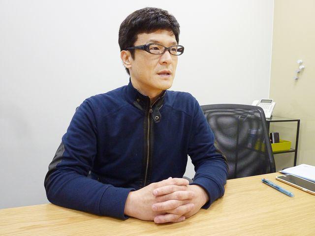 DMM　Bitcoinの田口 仁氏。オンラインを通じた株取引や金融デリバティブ取引等、インターネットを通じた様々な金融関連取引の市場を開拓してきた。