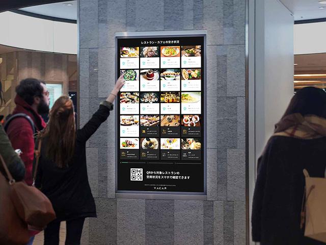 商業施設入口に設置されたサイネージ。上層階まで行かなくても「いま空いているか」がわかる。